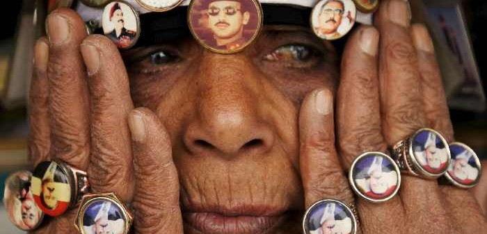 A woman with pins showing pictures of former President Saleh and his son at a rally against airstrikes, Sanaa, April 3, 2015. Mohamed Al-Sayaghi/Reuters/Corbis