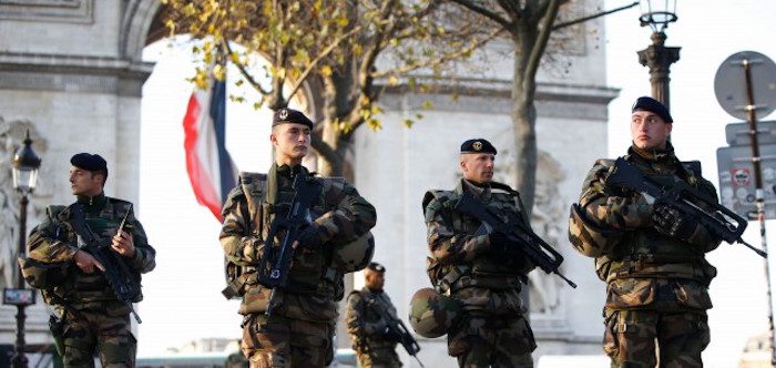 French soldiers patrol in front of the Arc de Triomphe, Paris