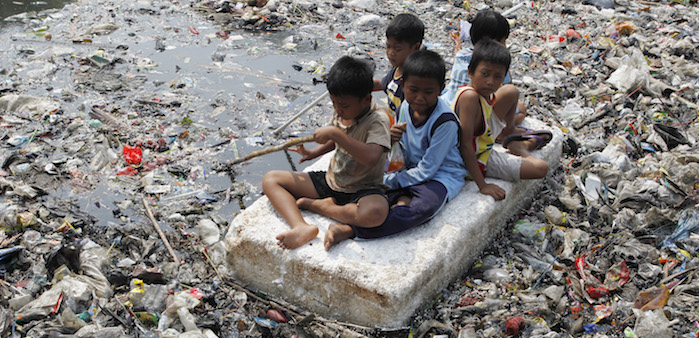 Children playing in a polluted river, Jakarta, Sept. 19, 2012. Enny Nuraheni/Reuters