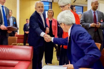 Iranian Foreign Minister Javid Zarif shakes hands with U.S. Secretary of State John Kerry, Vienna, July 14, 2015. U.S. Department of State