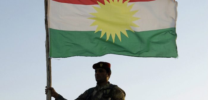 A Kurdish peshmerga soldier holds a Kurdistan flag in the northern Iraq, Ninawa province, Aug. 6, 2012. Azad Lashkari/Reuters