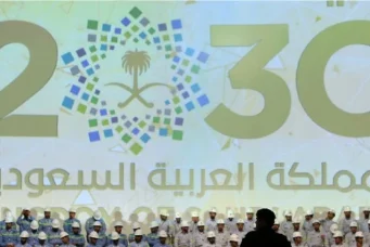 Large banner shows Saudi Vision for 2030 as a soldier stands guard at the inauguration of several energy projects in Ras Al Khair, Saudi Arabia. Nov. 29, 2016. Zuhair Al-Traifi/Reuters