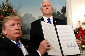 U.S. President Donald Trump holds up the proclamation that the United States recognizes Jerusalem as the capital of Israel and will move its embassy there, during an address from the White House in Washington DC, Dec 6, 2017. Kevin Lamarque/Reuters