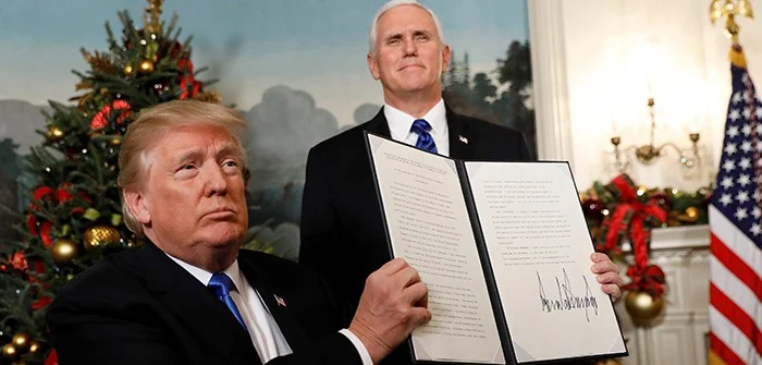 U.S. President Donald Trump holds up the proclamation that the United States recognizes Jerusalem as the capital of Israel and will move its embassy there, during an address from the White House in Washington DC, Dec 6, 2017. Kevin Lamarque/Reuters